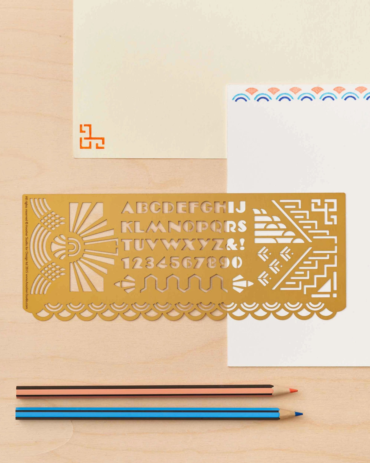 Brass art deco lettering stencil on cream cards with colored pencils