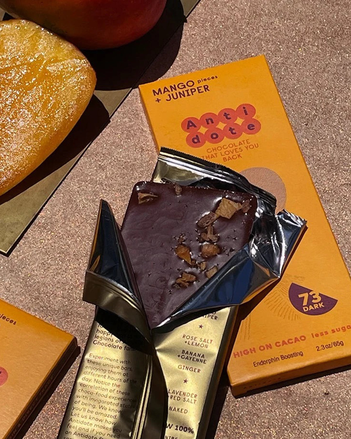 Mango and Juniper dark chocolate bar unwrapped from its gold foil