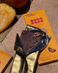 Mango and Juniper dark chocolate bar unwrapped from its gold foil