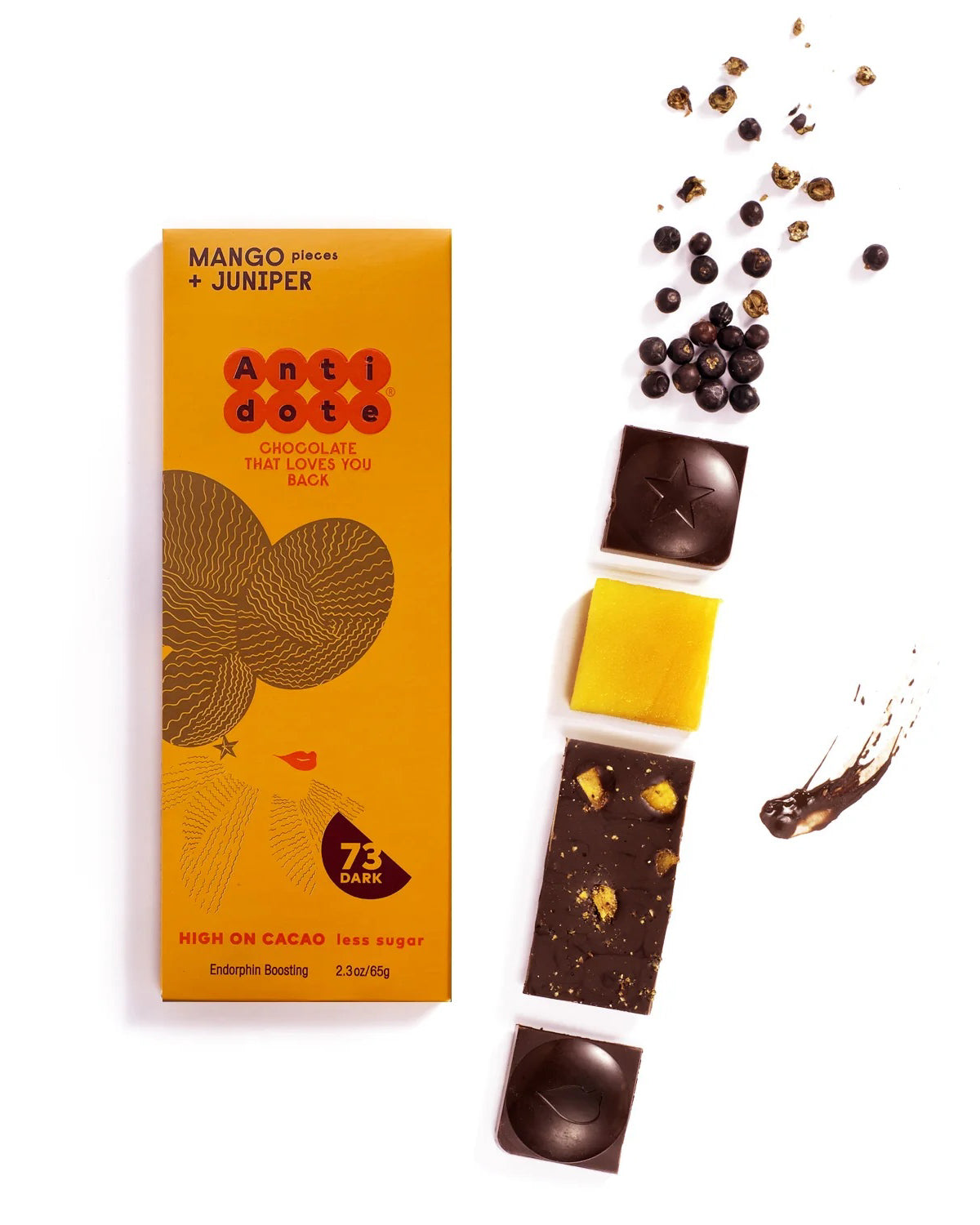 Antidote Mango and Juniper 73% dark chocolate bar in orange wrapping beside chocolate pieces
