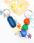 Colorful bottle openers on a playful painted background. 