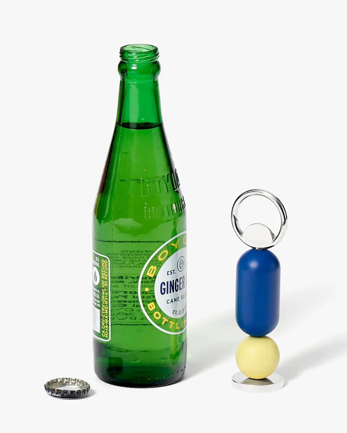 Blue, yellow bottle opener next to a green glass bottle. 