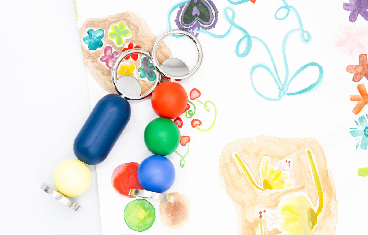 Colorful bottle openers on a playful painted background. 