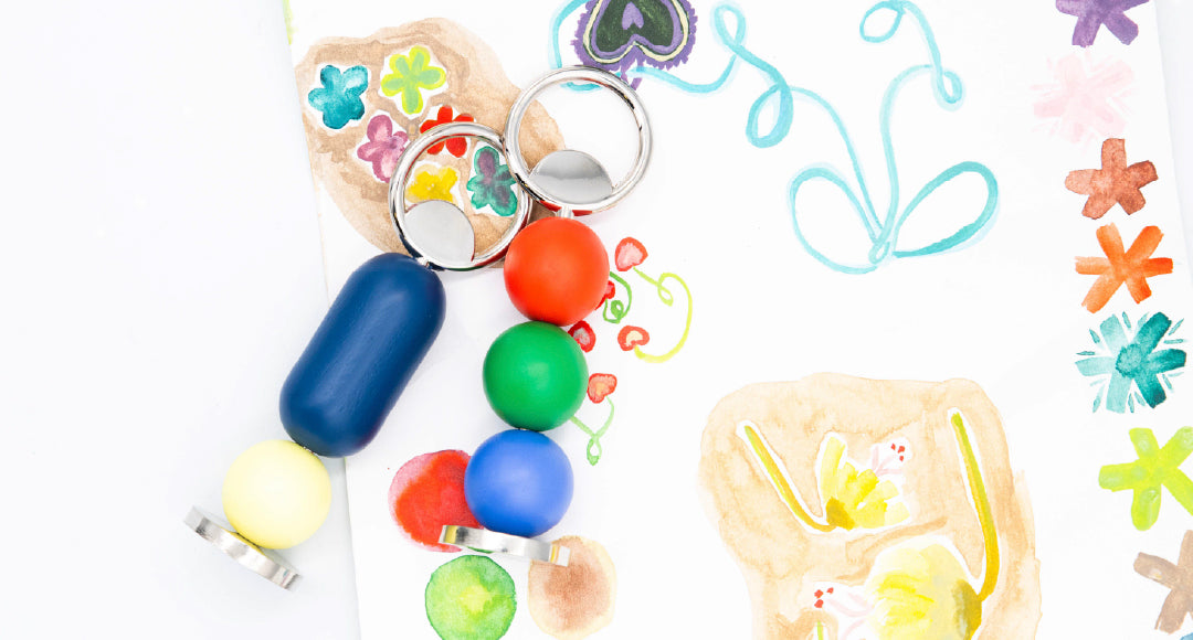 Colorful bottle openers on a playful painted background. 