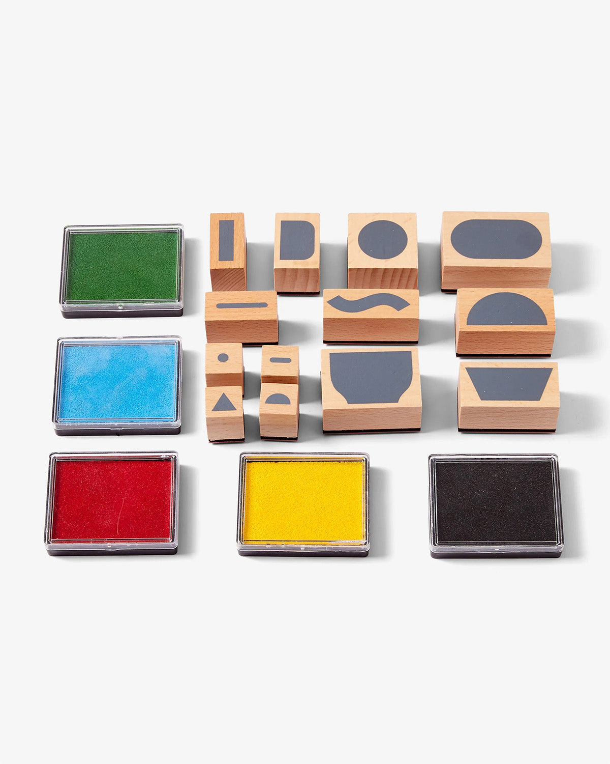 Set of wooden stamps with colorful ink pads on a white background