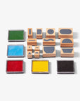 Set of wooden stamps with colorful ink pads on a white background