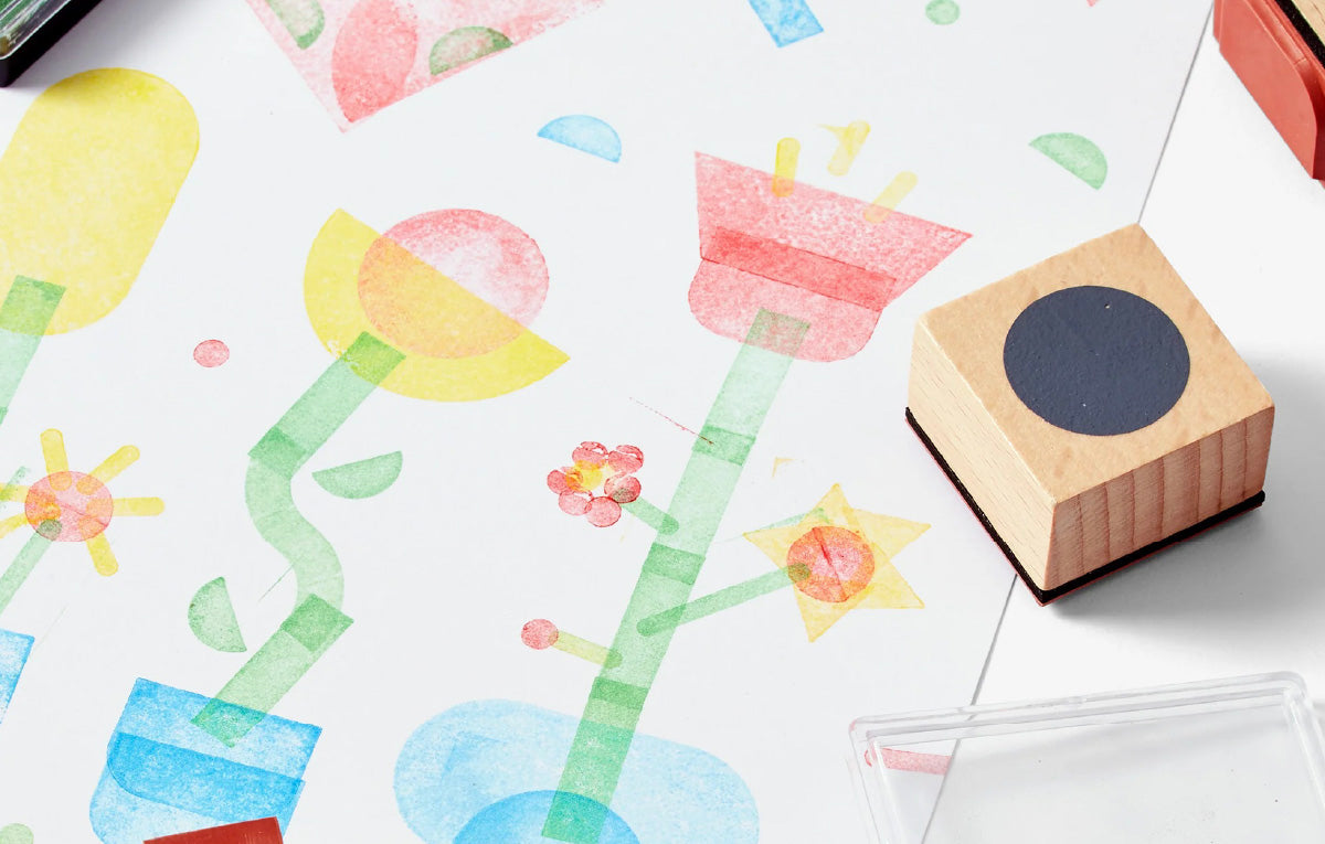 Wooden stamp with colorful floral design on a white surface