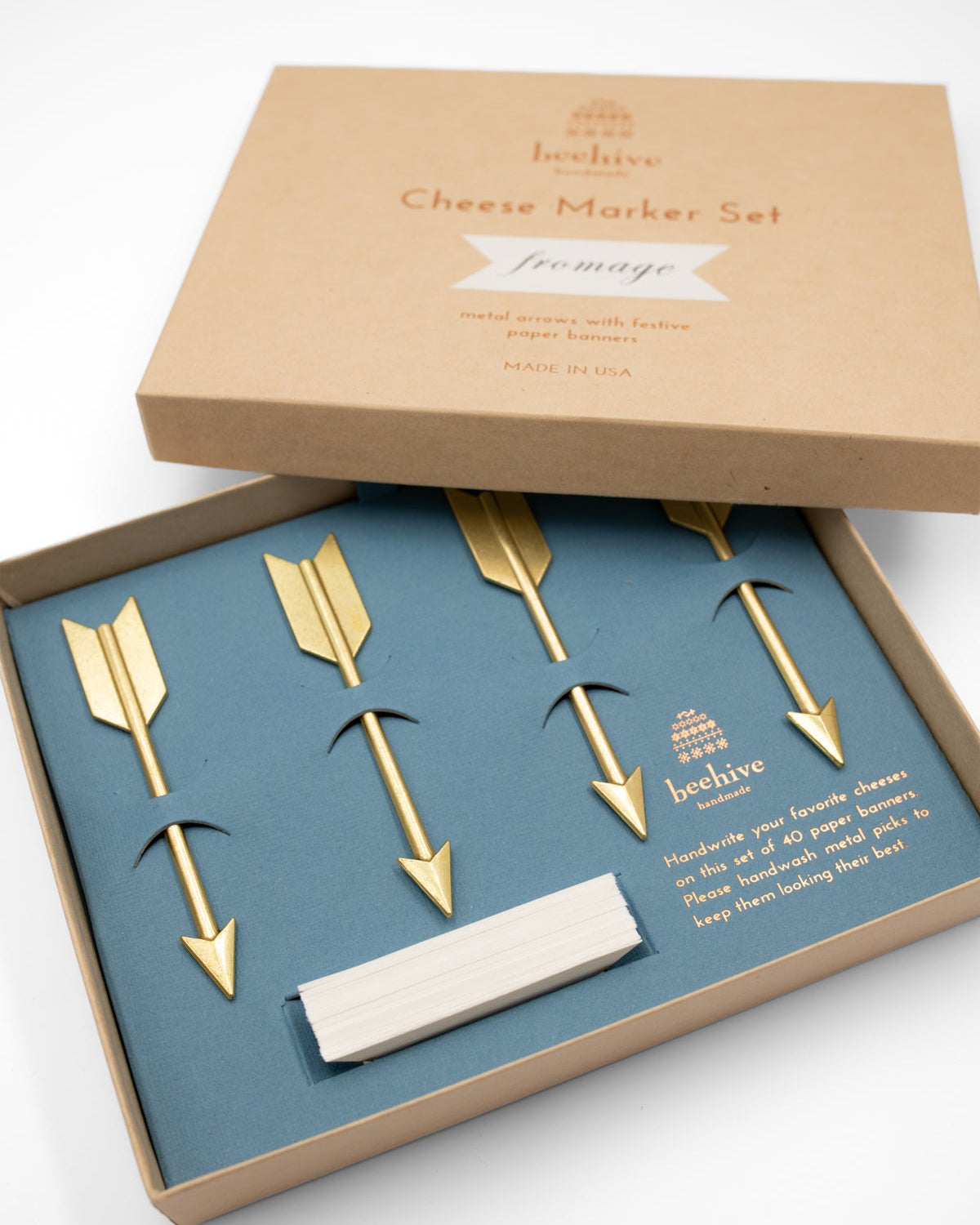 Beehive Handmade set of four gold arrow cheese markers in a blue-lined kraft gift box
