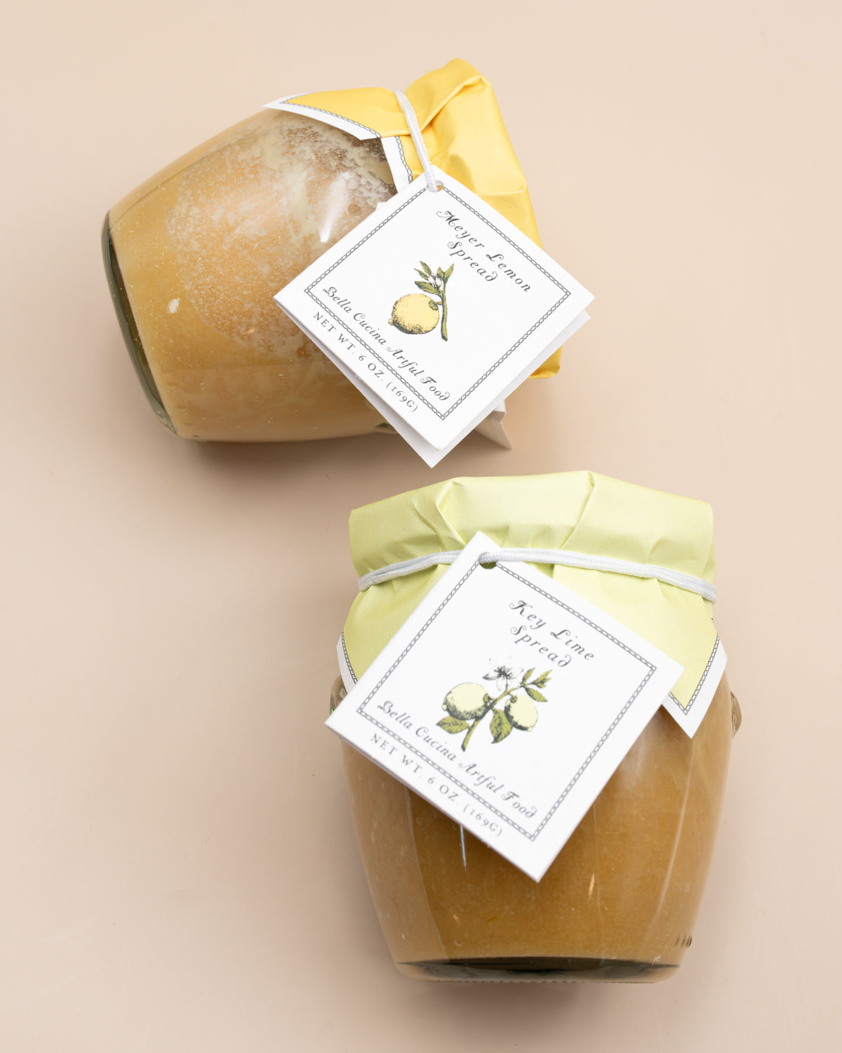 Close-up of Key Lime and Meyer Lemon curd-style spread jars with hang tags