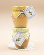 Stacked jars of Bella Cucina Meyer Lemon and Key Lime spreads with fabric lids and tags