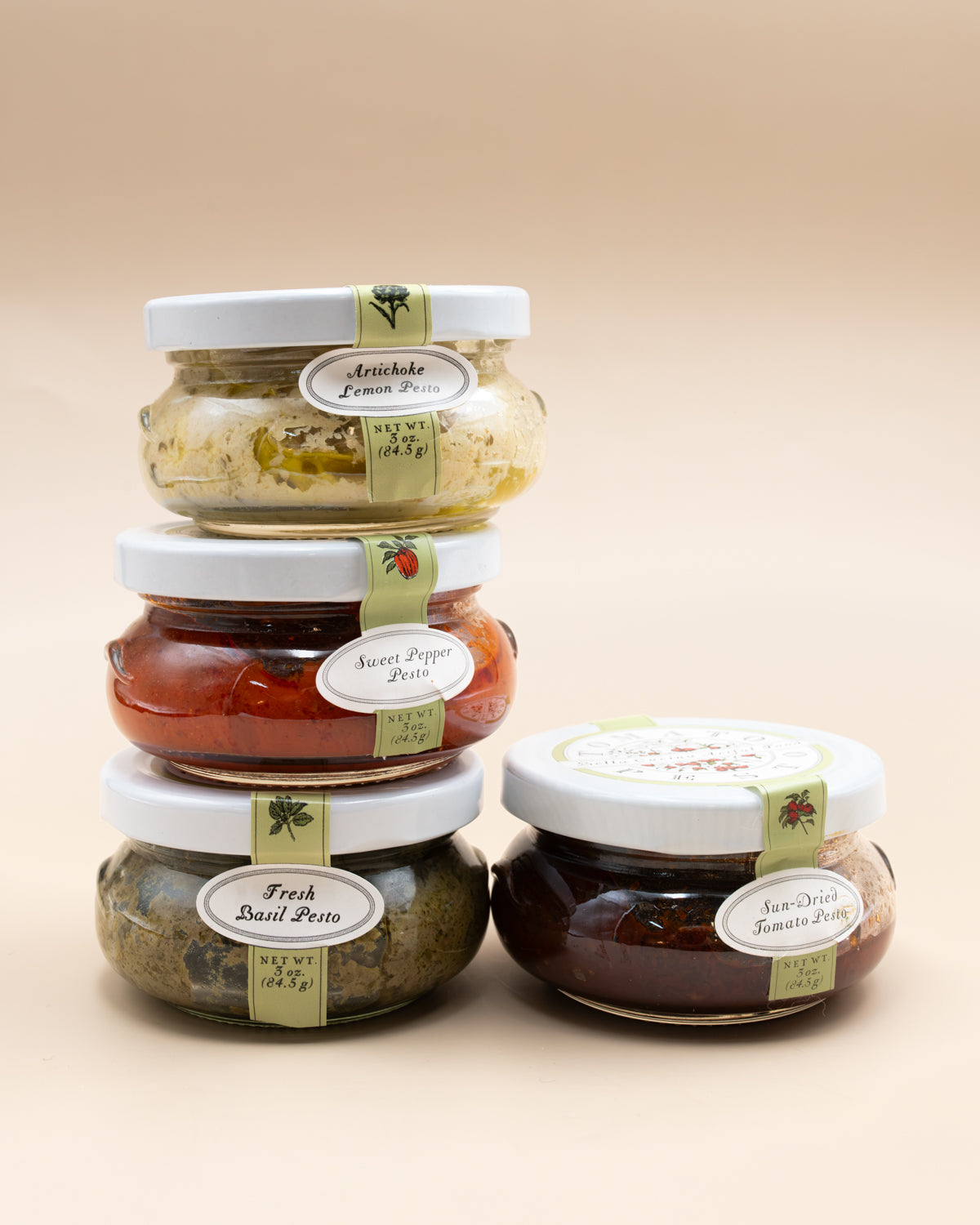 Four 3 oz Bella Cucina pesto jars: basil, artichoke lemon, sweet pepper and sun-dried tomato