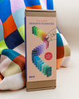 Block Design Gradient Dominoes box standing on a colorful knit blanket