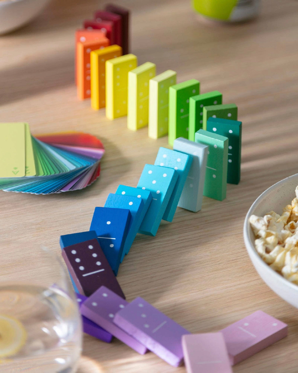 Block Design Gradient Dominoes in rainbow colors lined up in a curve on a table