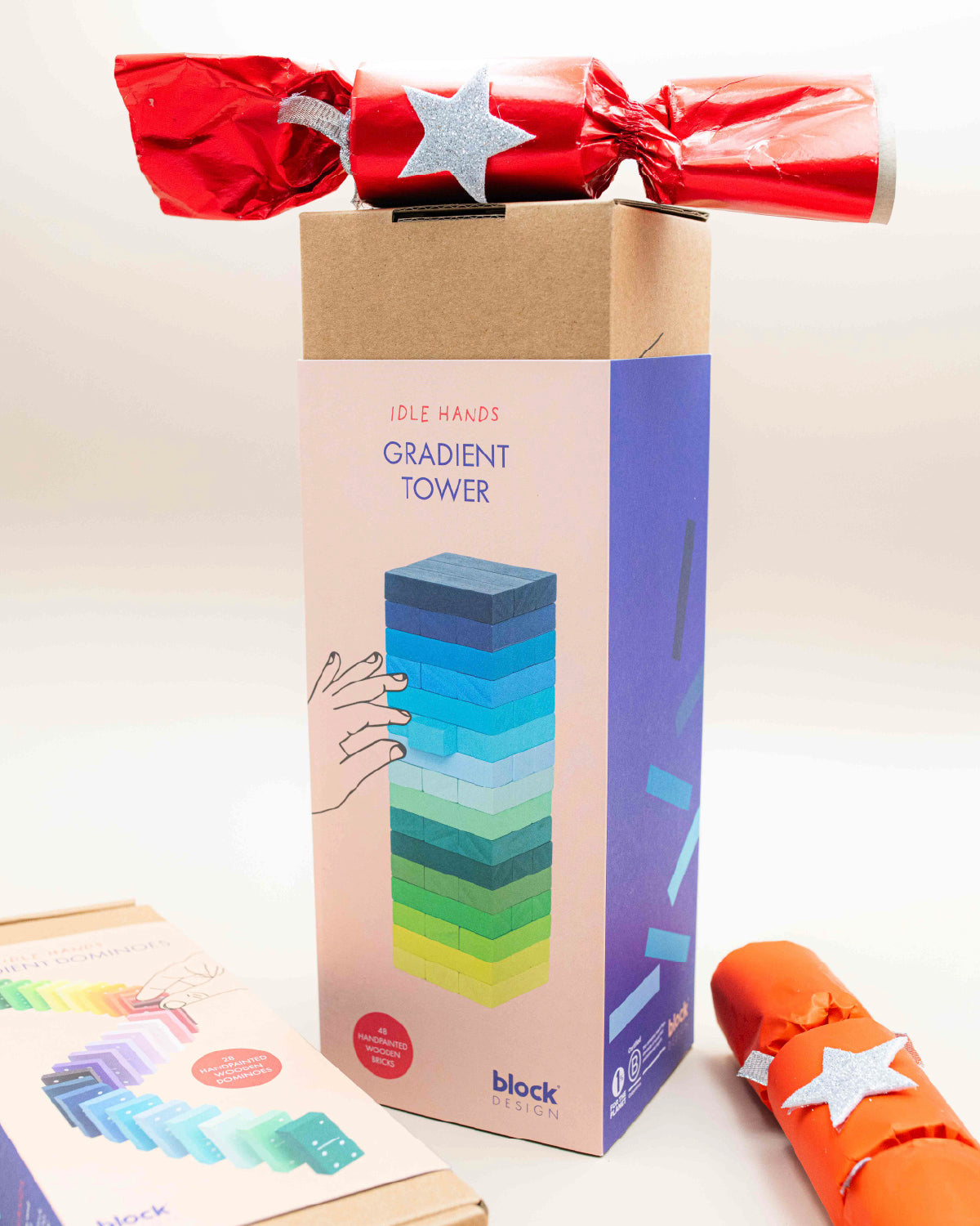 Block Design Gradient Tower box beside the Gradient Dominoes box with a red ribbon