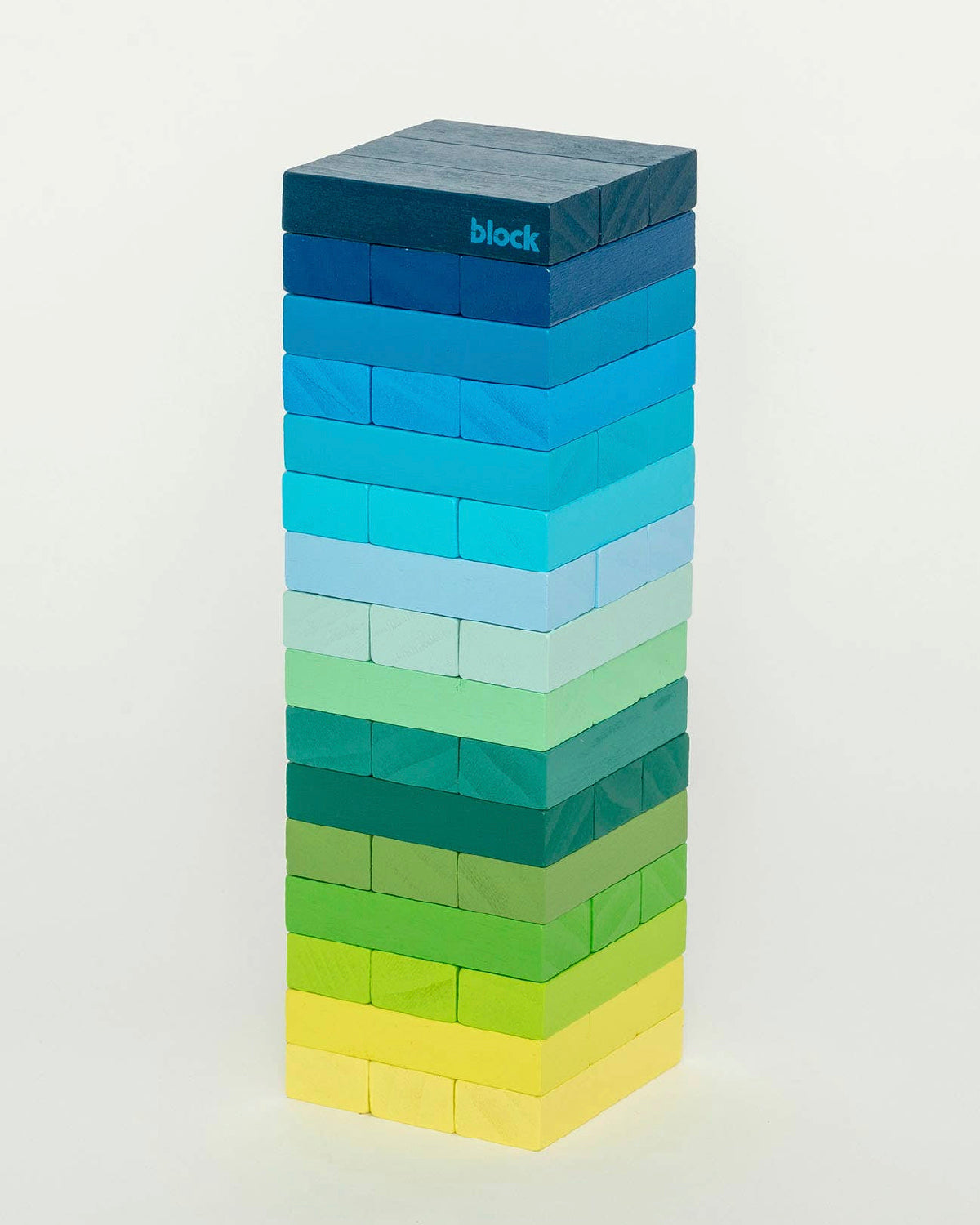 Gradient Tower stacking game in blue, teal, green and yellow wood blocks on white