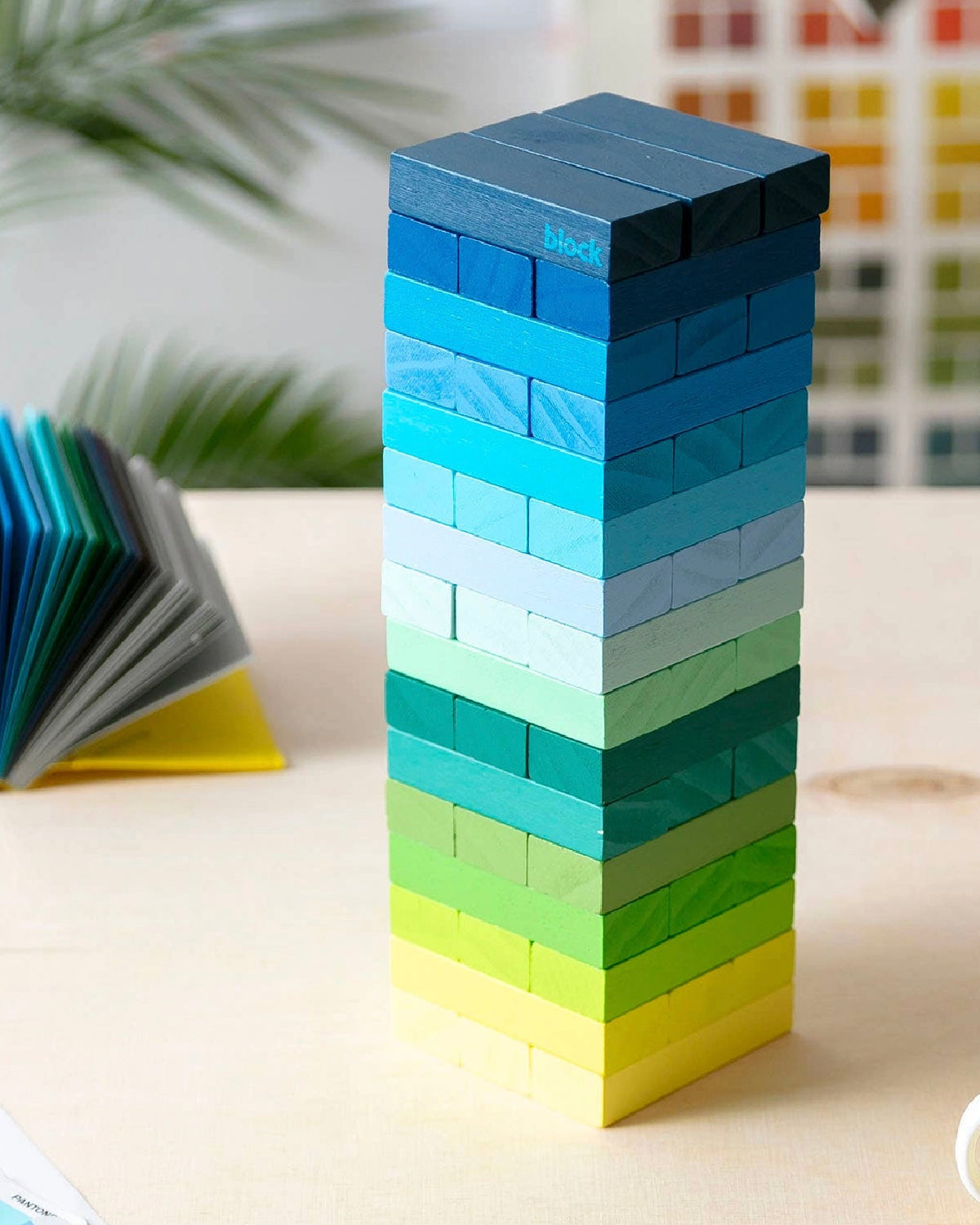 Block Design Gradient Tower of wooden blocks shading from navy to yellow on a table