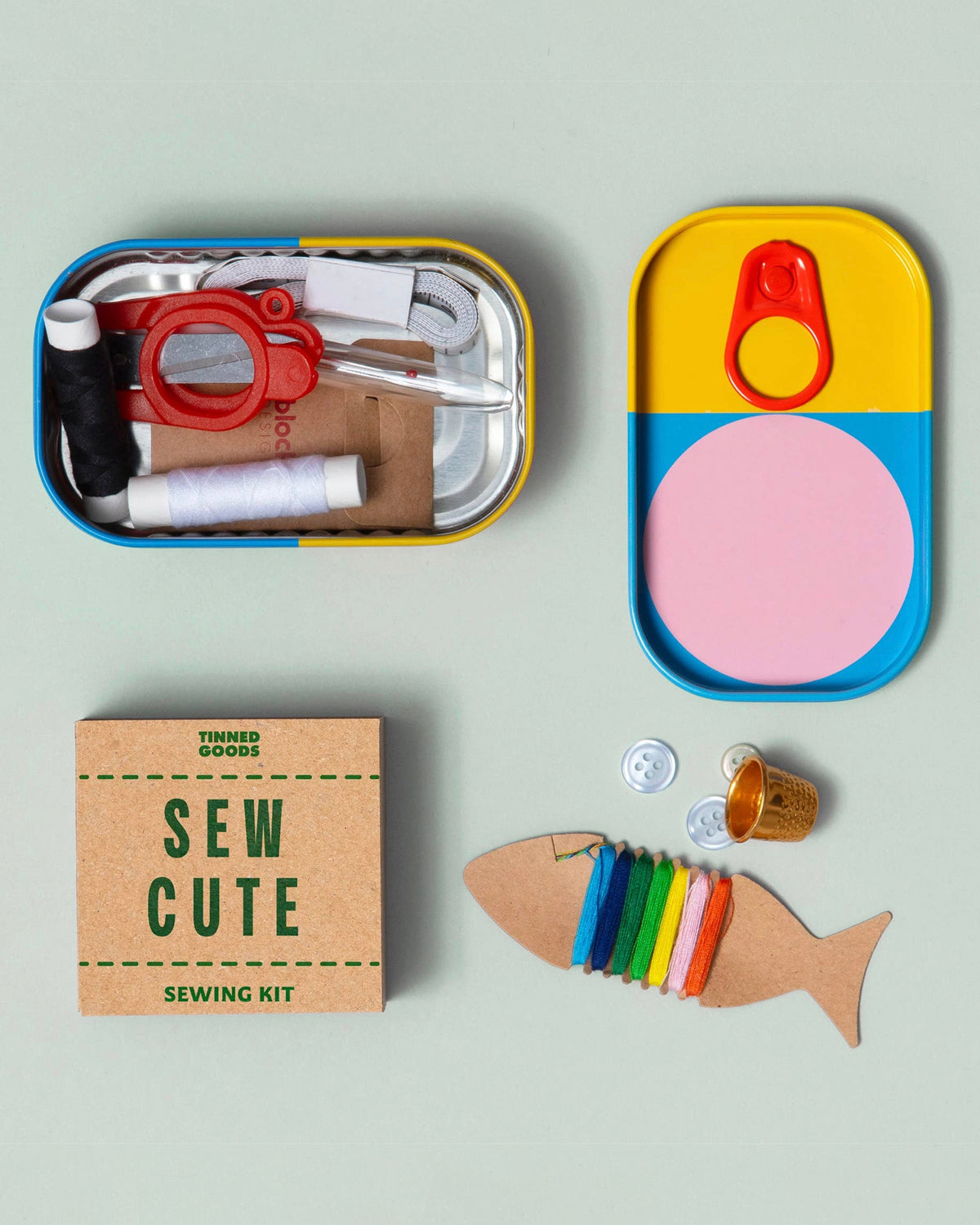 Open Sew Cute tin showing mini scissors, thread and needles beside a fish-shaped thread card