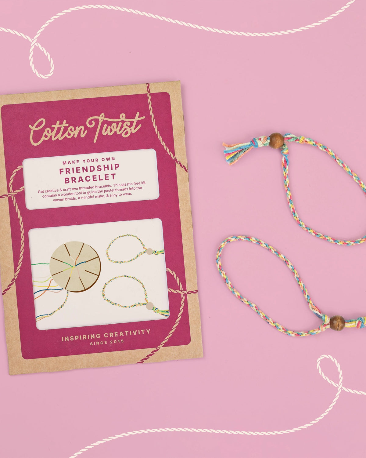 Cotton Twist friendship bracelet kit and finished bracelet on a pink background