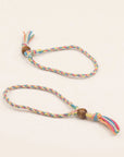 Two finished rainbow braided friendship bracelets with wooden beads