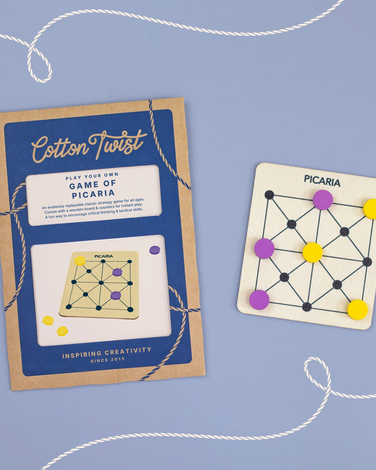 Cotton Twist Game of Picaria packaging and board on a periwinkle background