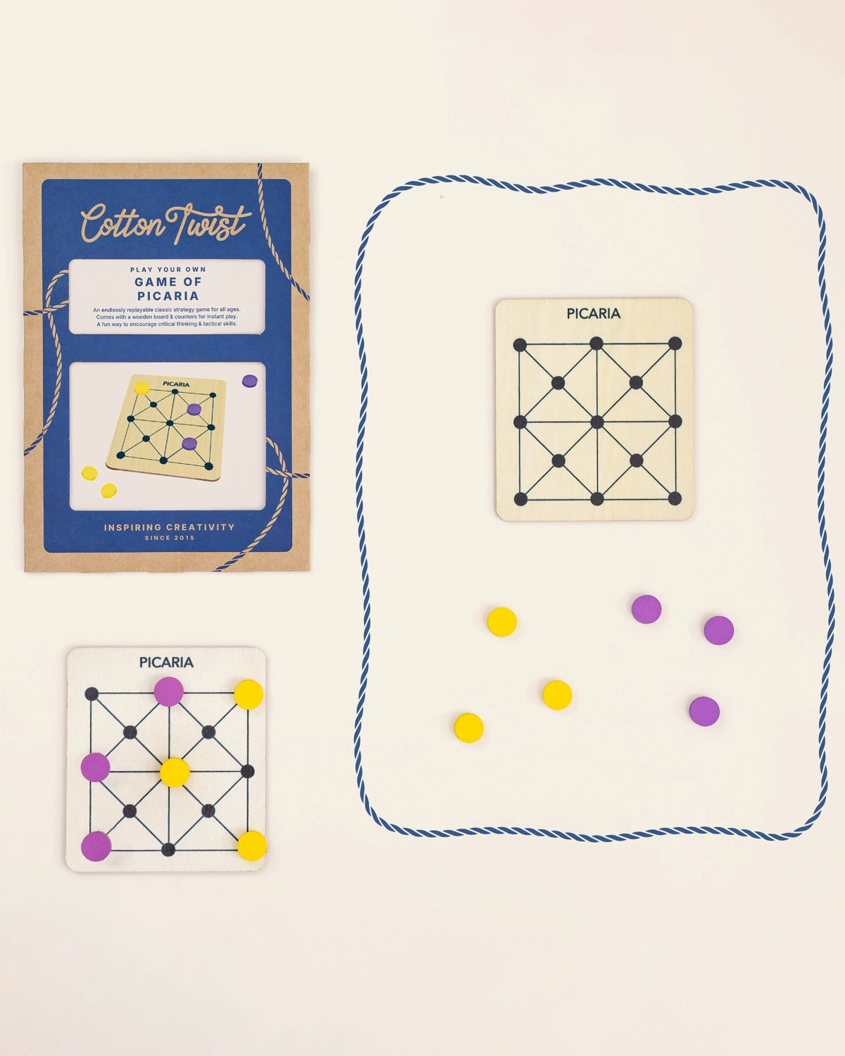 Cotton Twist Game of Picaria kit: blue envelope, wooden board and yellow and purple tokens