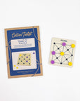 Game of Picaria in blue kraft packaging beside the wooden board