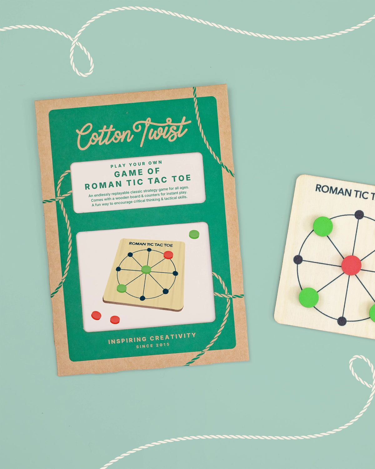 Cotton Twist Roman Tic Tac Toe packaging and board on a mint background