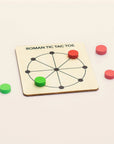 Round wooden Roman Tic Tac Toe board with red and green wooden tokens