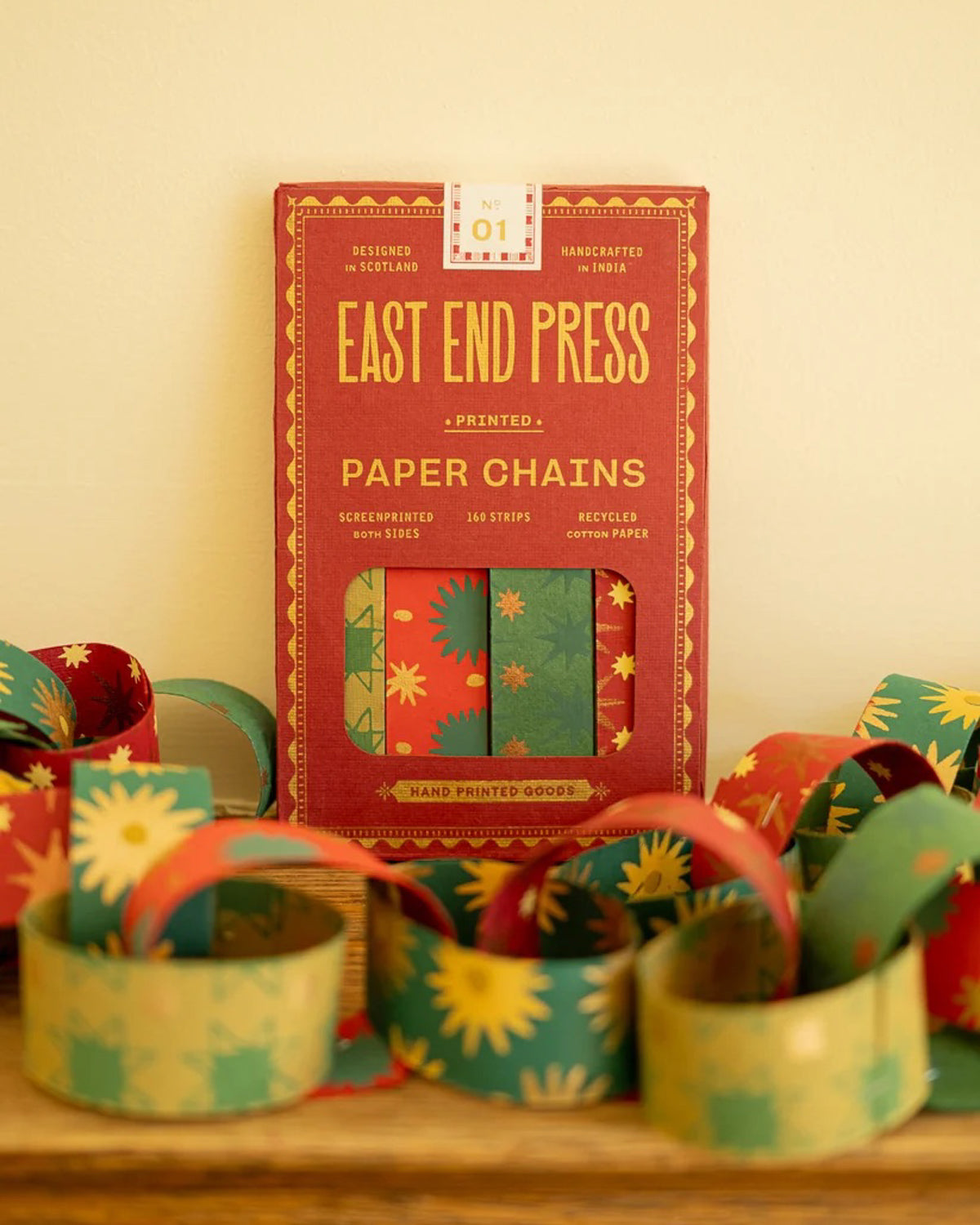 East End Press Paper Chains kit in its red packet with patterned paper chain loops