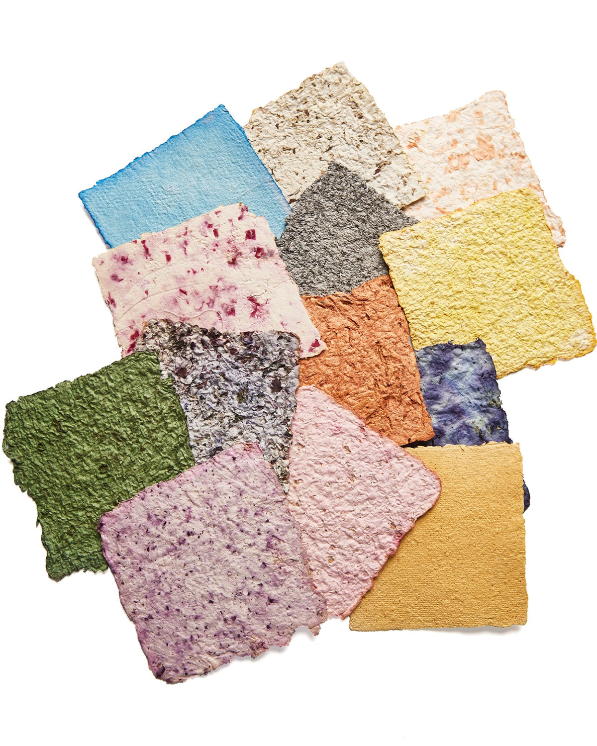 Handmade paper squares in green, pink, gold and gray, flecked with dried herbs and flowers