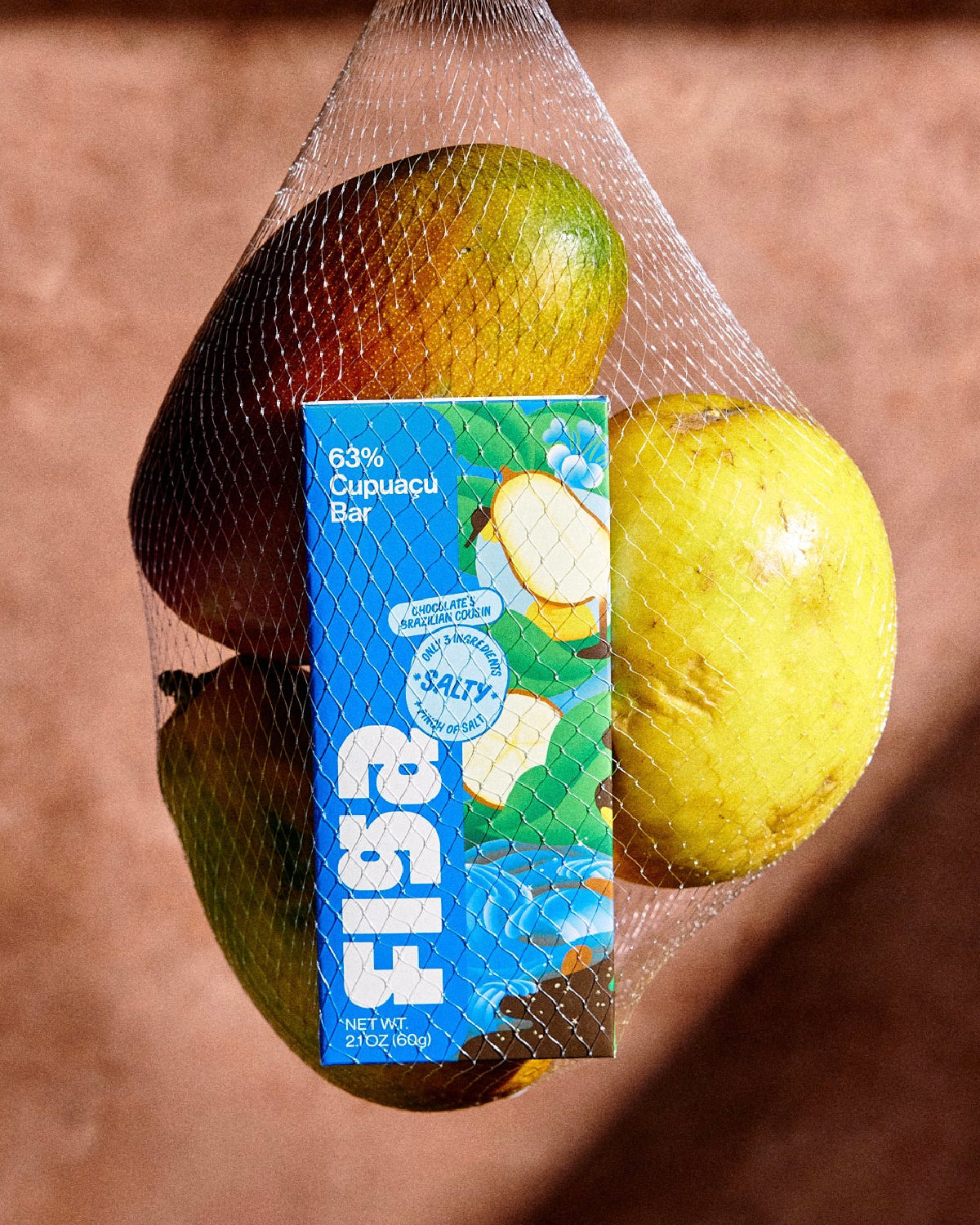 Figa cupuacu bar in a mesh produce bag with mangoes