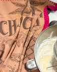 Tasse de Chocolat jacquard towel in cocoa brown beside a mixing bowl of frosting