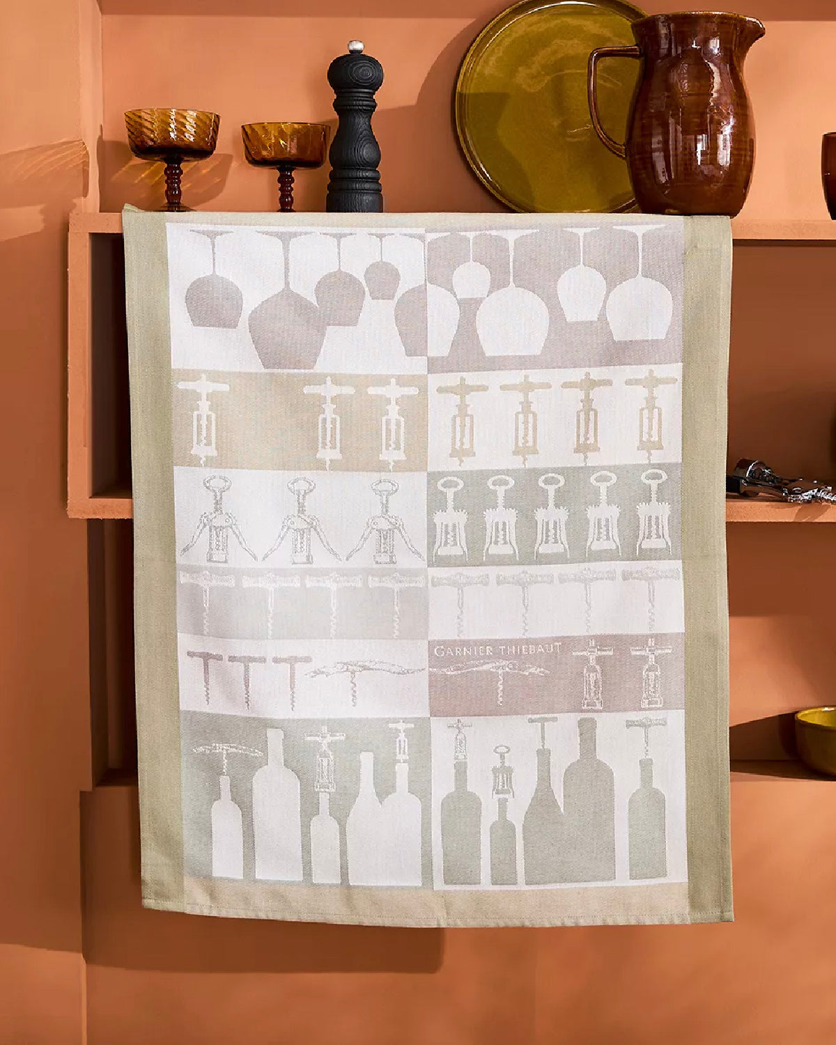 Sommelier jacquard kitchen towel with wine glasses, corkscrews and bottles hung on a shelf