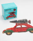 Jiggies mini puzzle of a red car with a Christmas tree on top, beside its teal box
