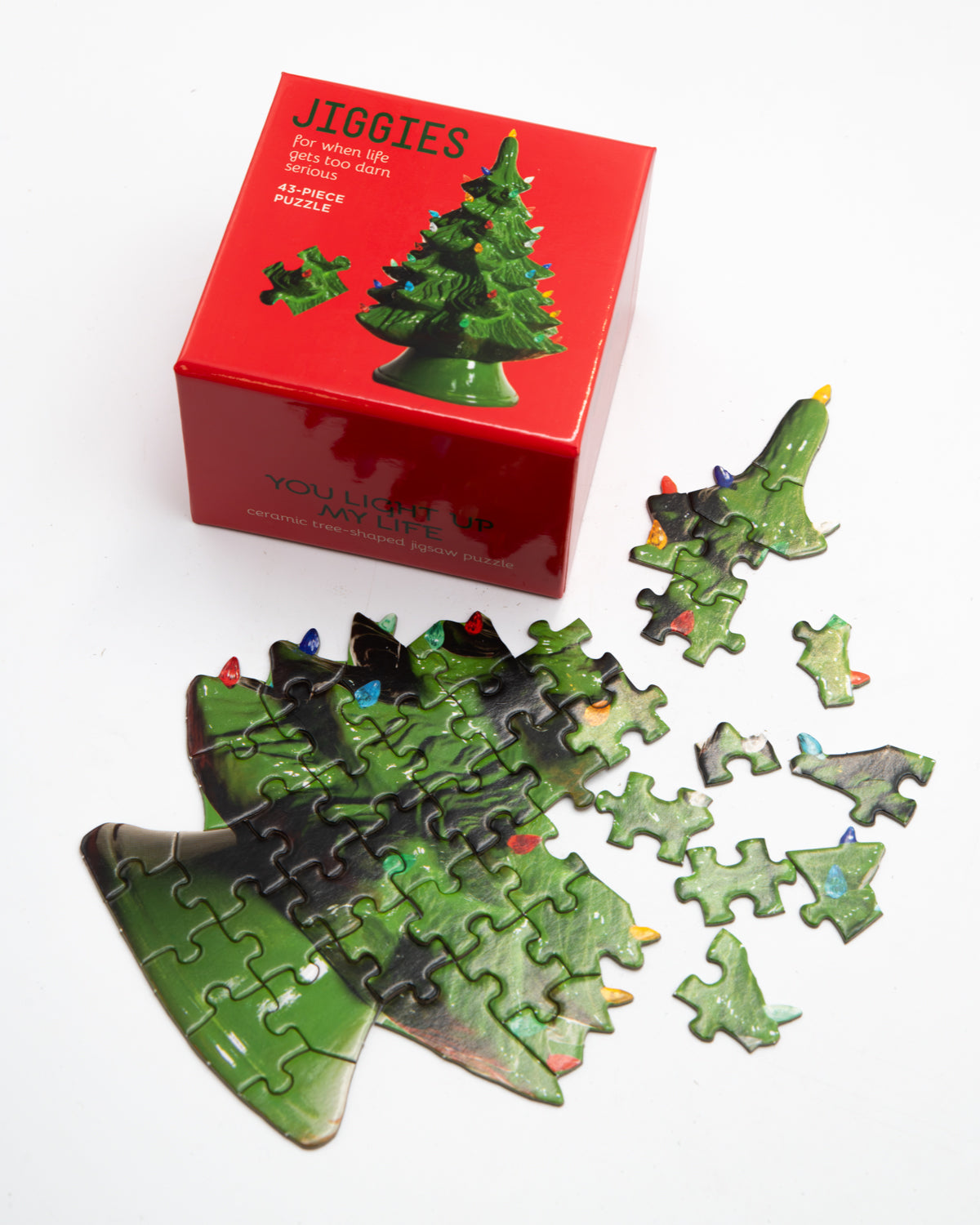 Christmas tree Jiggies mini puzzle in progress with loose pieces and its red box