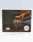 Gingko Amber Crystal Light box showing the solar system crystal ball on walnut