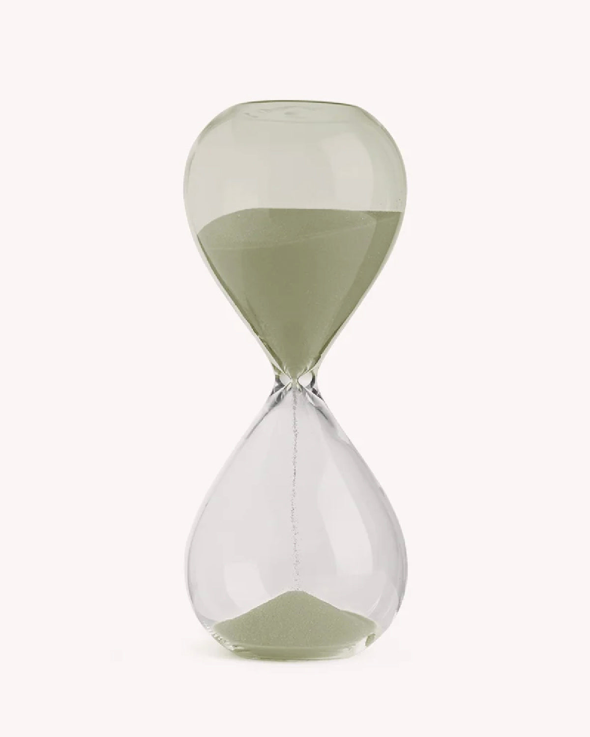 Glass desktop hourglass with pale sage green sand on a white background