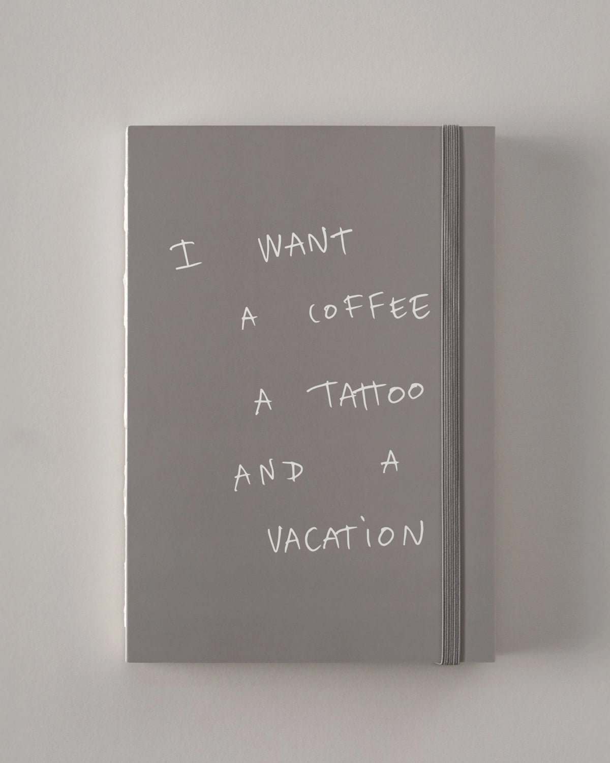 Gray Poète notebook with the cover quote I want a coffee, a tattoo and a vacation