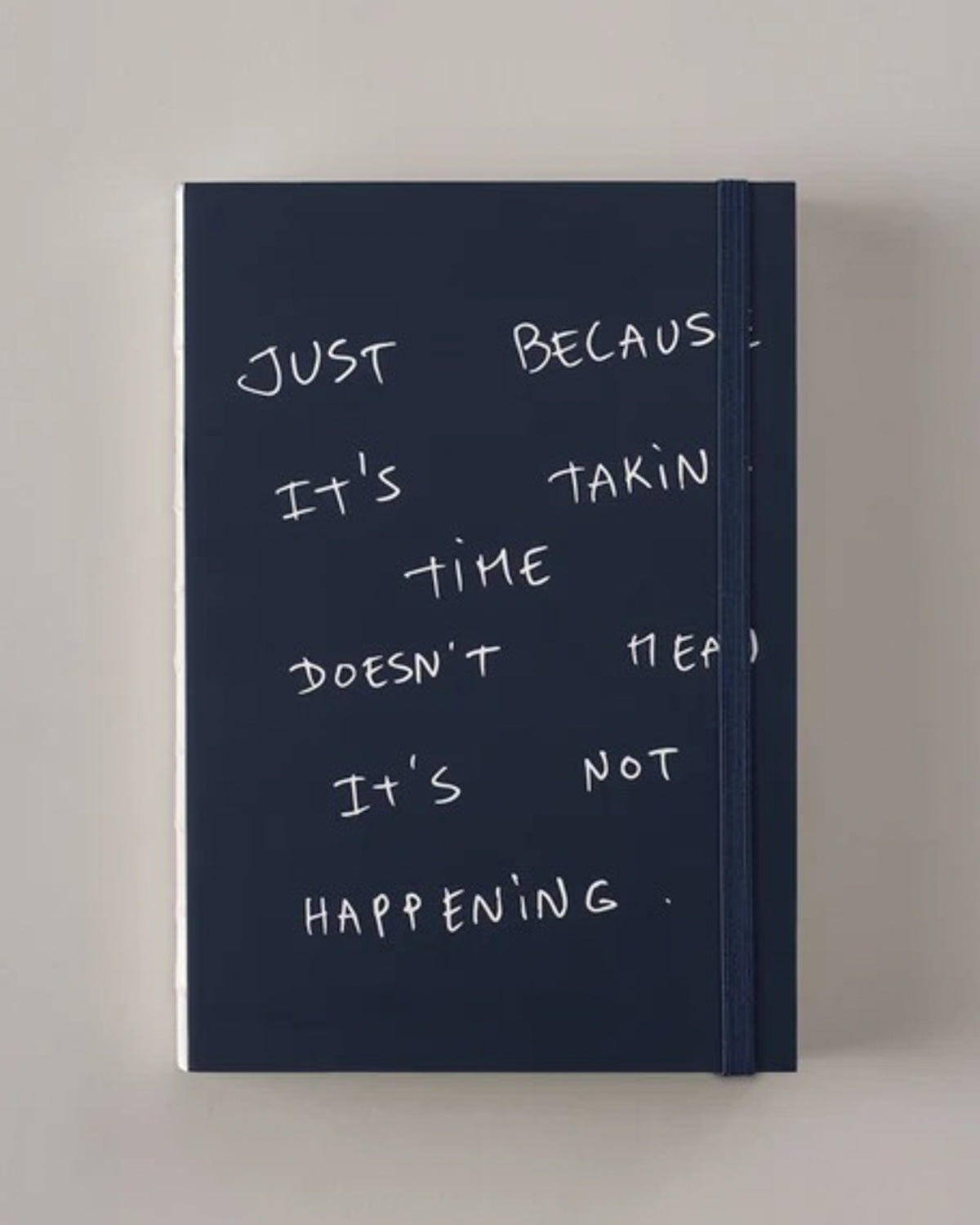 Navy Poète notebook with a handwritten cover quote about progress taking time