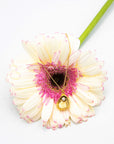 Gold-plated necklace with a shell, glass pearl pendant on a white flower