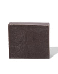 Square block of dark kitchen soap by small business, Mayron's Goods, on a white background
