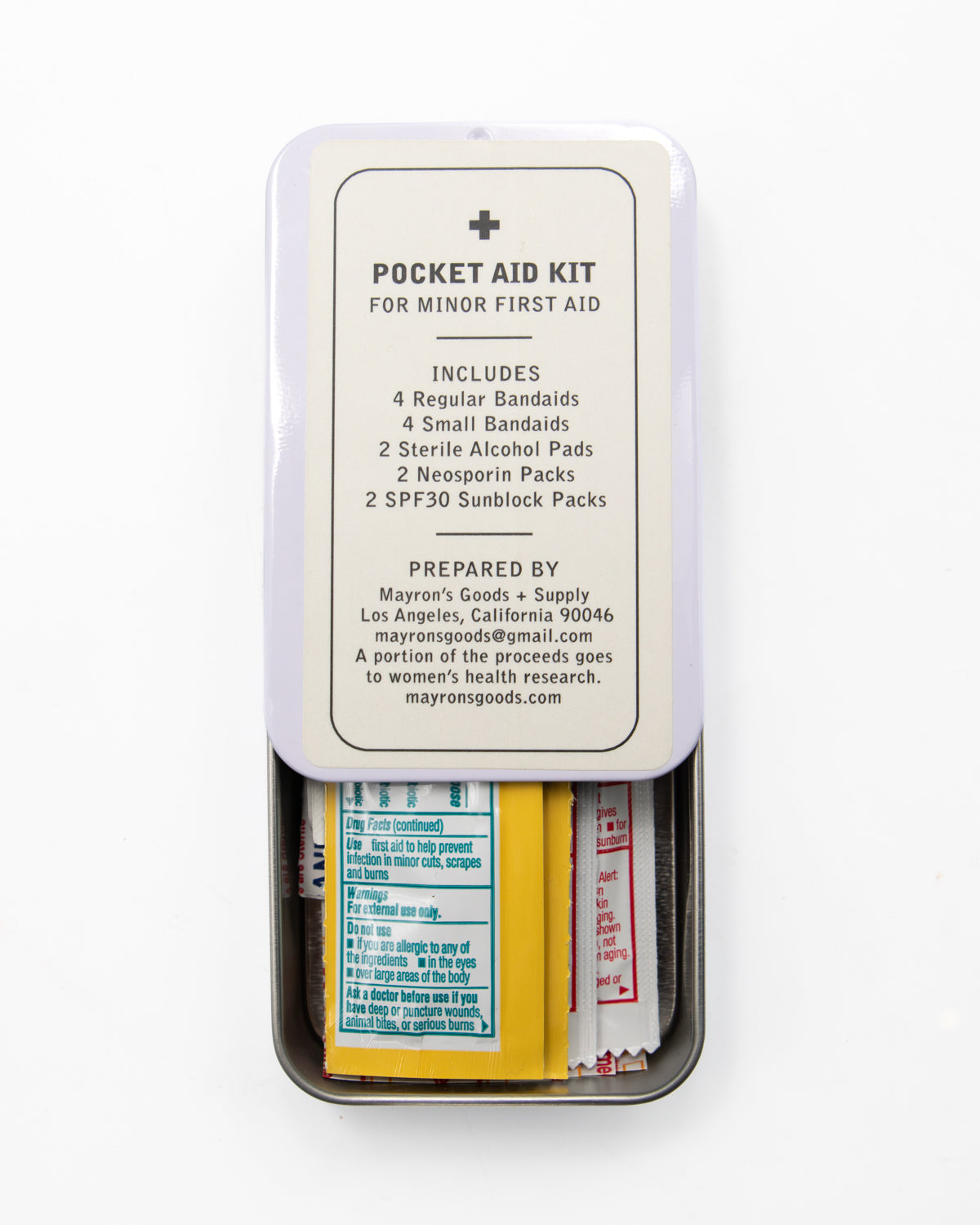 Open Mayron's Goods Pocket Aid Kit tin showing bandages and first aid packets