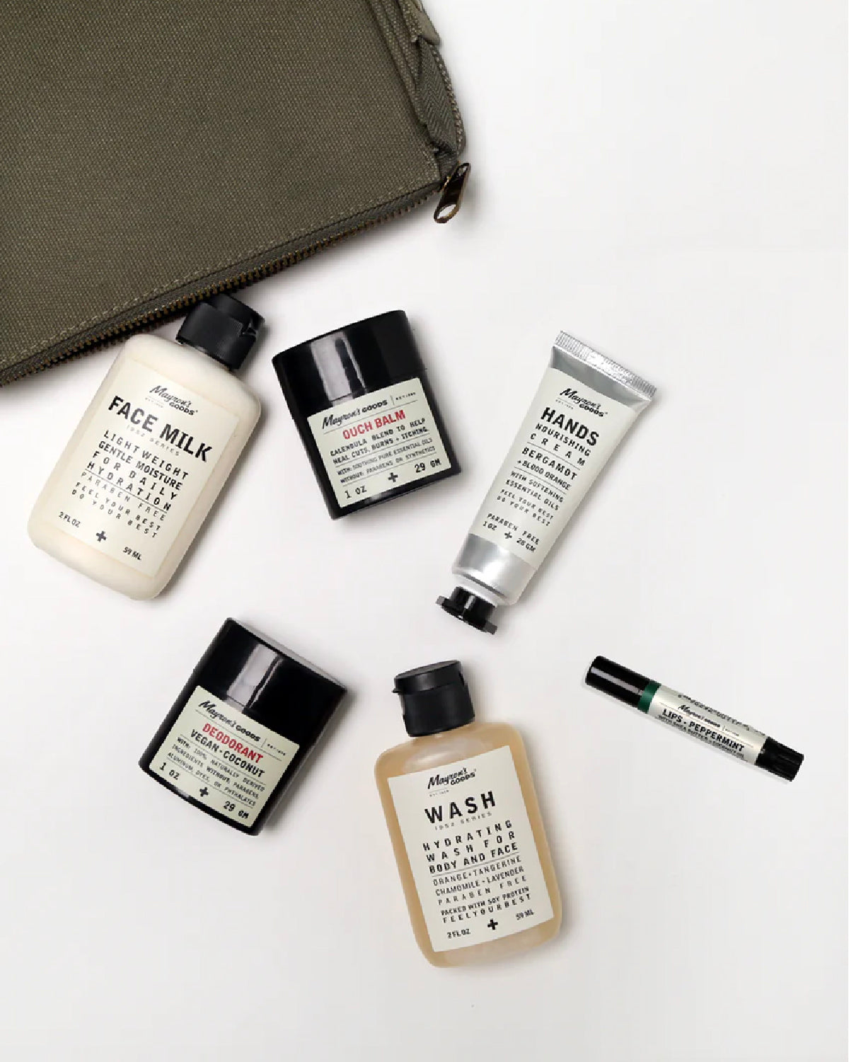 Collection of Mayron's Goods Road Pack Kit personal care products on a white background including Face Milk, Ouch Balm, Hand Crean, Deodorant, Body and Face Wash and Lip Balm.