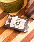 Boxed Mayron's Goods Spice Soap on a striped wooden cutting board