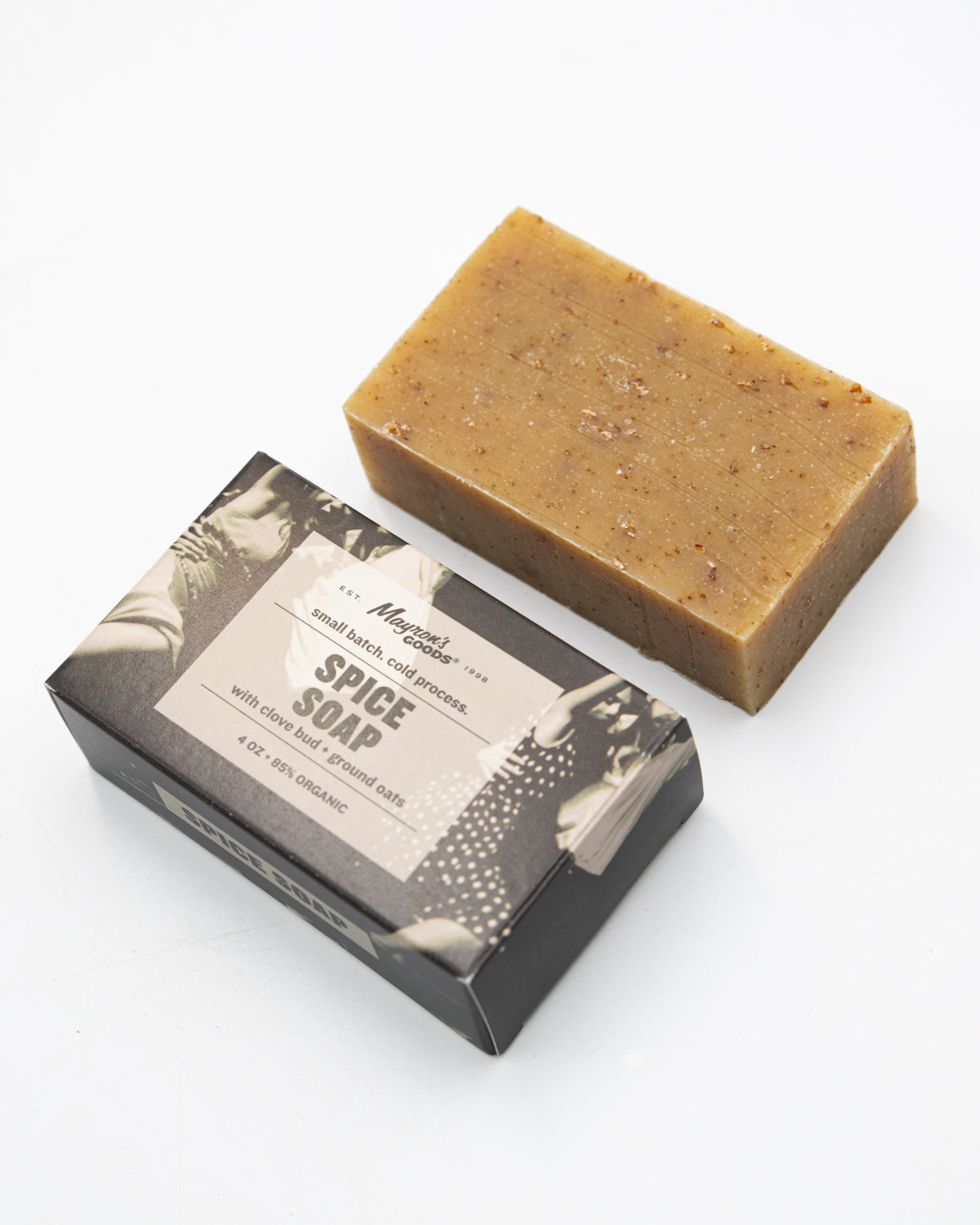 Mayron's Goods oat-flecked spice soap bar beside its black and white box