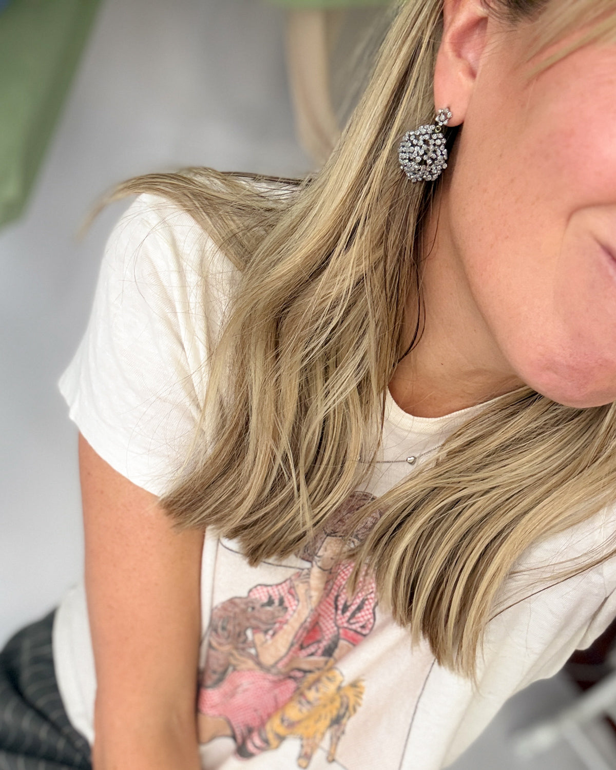 Woman wearing a pair of Michael Michaud's Queen Anne's Lace cluster earrings cast from real flowers, dusted with crystal