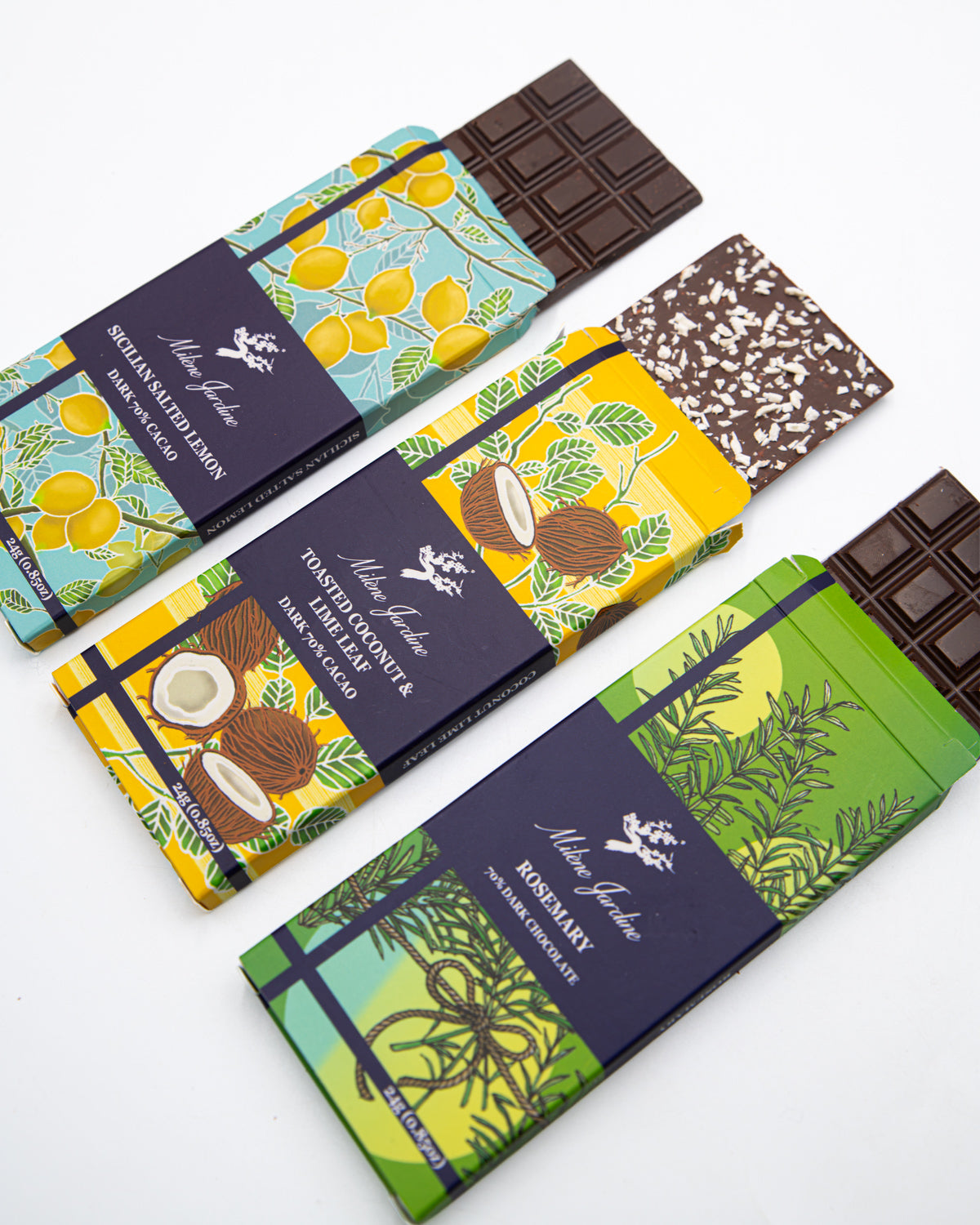 Three Milene Jardine tasting bars sliding out of lemon, coconut and rosemary wrappers