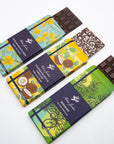 Three Milene Jardine tasting bars sliding out of lemon, coconut and rosemary wrappers