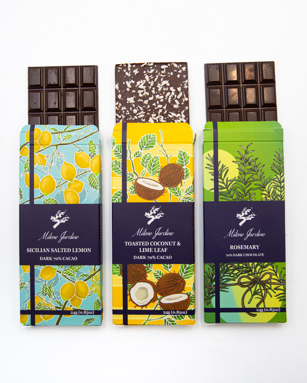 Three Milene Jardine dark chocolate bars partly unwrapped: lemon, coconut and rosemary