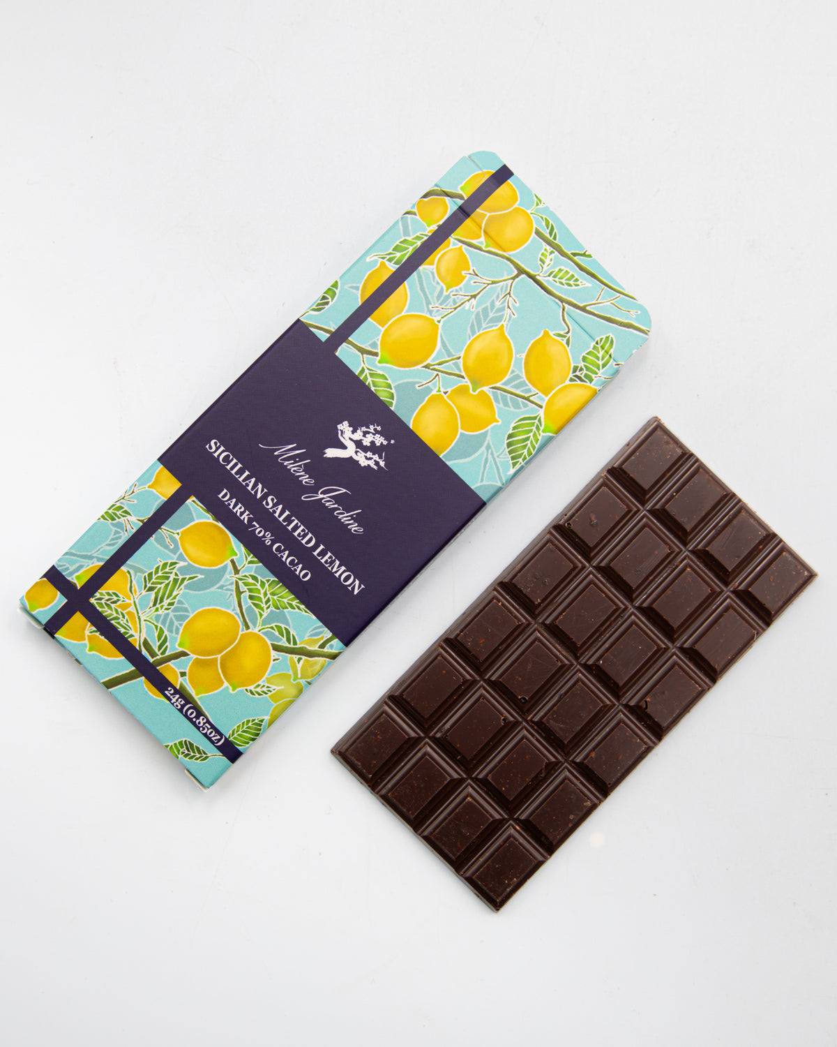Milene Jardine Sicilian Salted Lemon bar beside an unwrapped dark chocolate bar